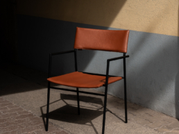 Montis chair in brown leather in the sun with hard shadows during Milan design week 2024