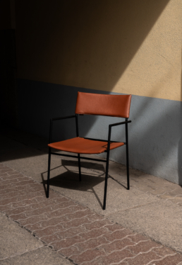 Montis chair in brown leather in the sun with hard shadows during Milan design week 2024